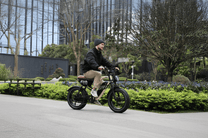 Man riding the OneSport W66 fat-tyre e-bike on a footpath