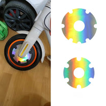Close-up of reflective safety sticker for wheel cover in holographic finish on the electric scooter