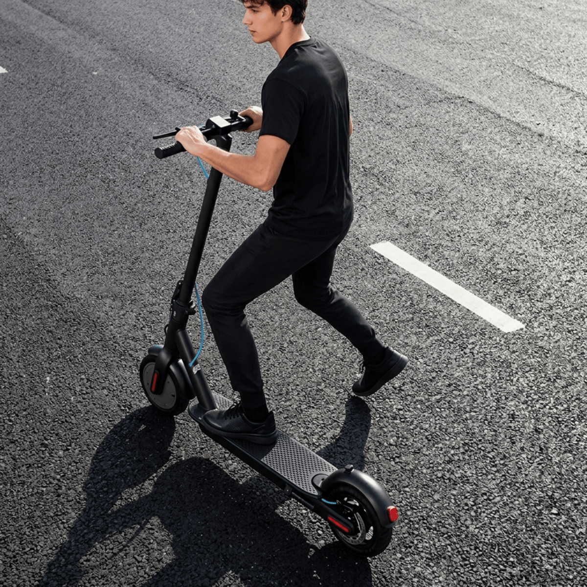 Man riding the SEEDREAM RED WING MINI electric scooter on a road