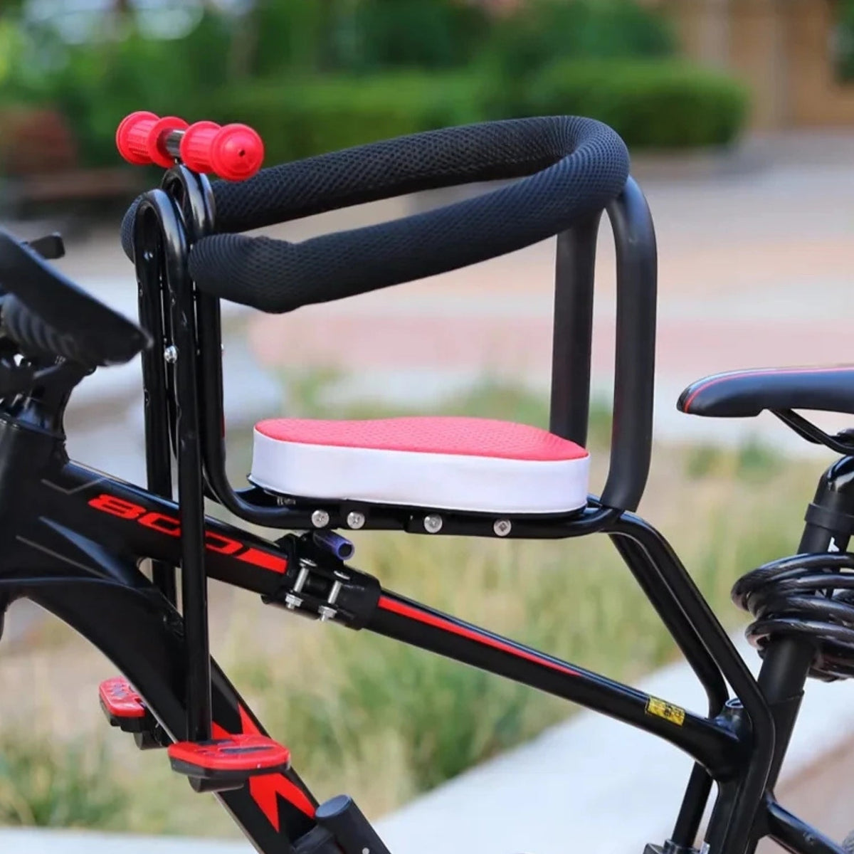Smart child seat for bike frames in red fitted on a bicycle