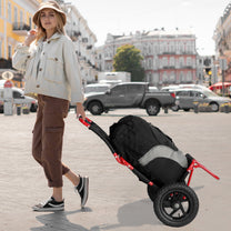 Person pulling the Smart cargo bike trailer in hand-cart mode in town