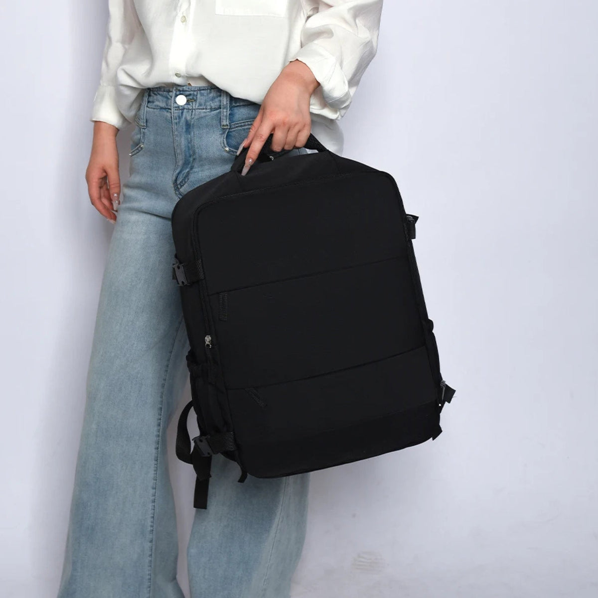 Smart backpack Splash Edition in black being carried by the handle