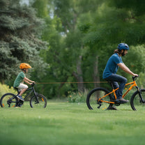Smart retractable bike tow rope with hook towing a child’s bicycle