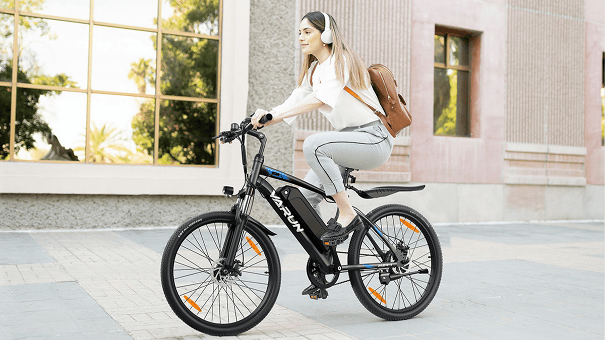 Woman riding the VARUN M24-1 electric mountain bike in black in the city