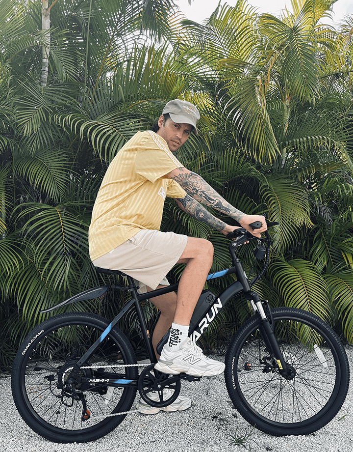 Man riding the VARUN M24-1 electric mountain bike in black
