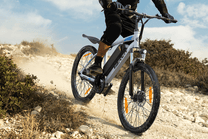Rider taking the VARUN M24-1 electric mountain bike off-road