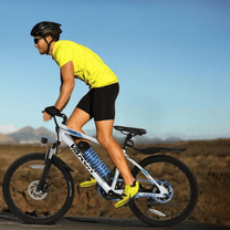 Man riding the VARUN M24-1 electric mountain bike in white wearing a helmet on a road