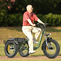 Man riding the Hidoes ET1 electric tricycle in a park