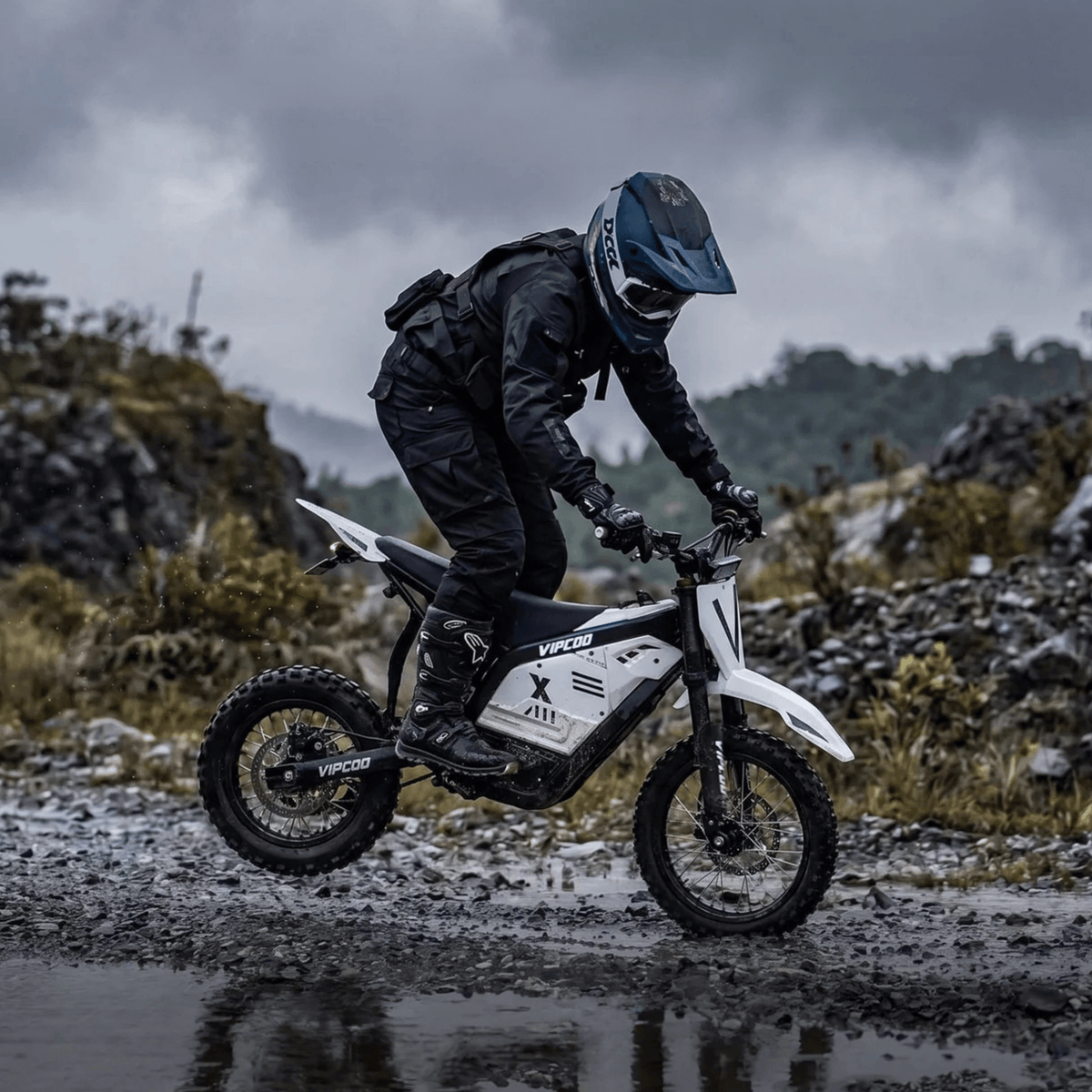 Rider taking the Vipcoo H2 electric dirt bike off-road on a road