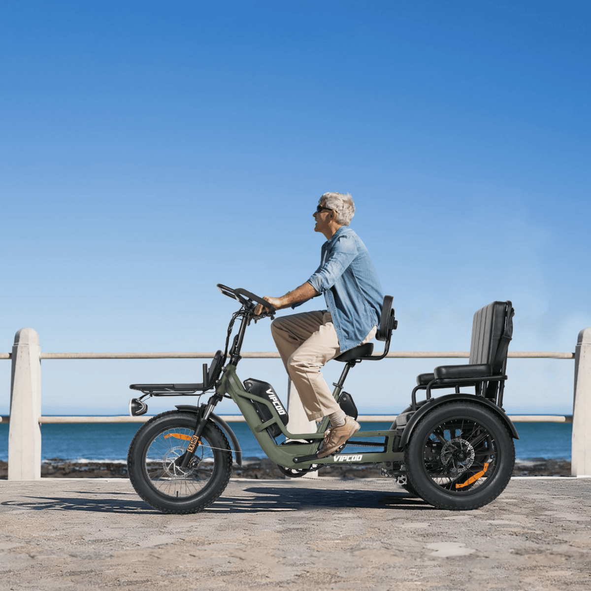 Person riding the VIPCOO R1 electric tricycle by the sea