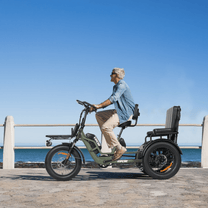 Person riding the VIPCOO R1 electric tricycle by the sea