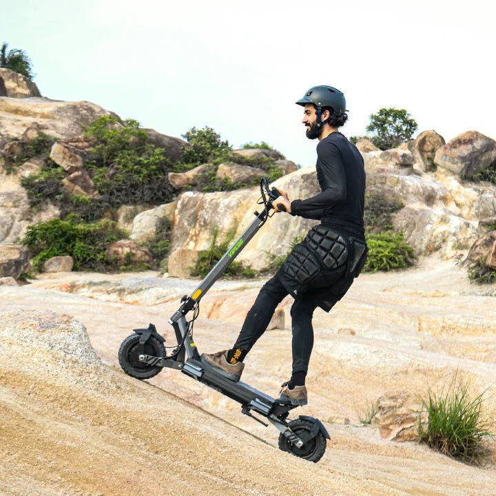 Man riding the VIPCOO VS6 electric scooter on a trail