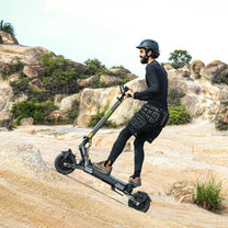Man riding the VIPCOO VS6 electric scooter on a trail