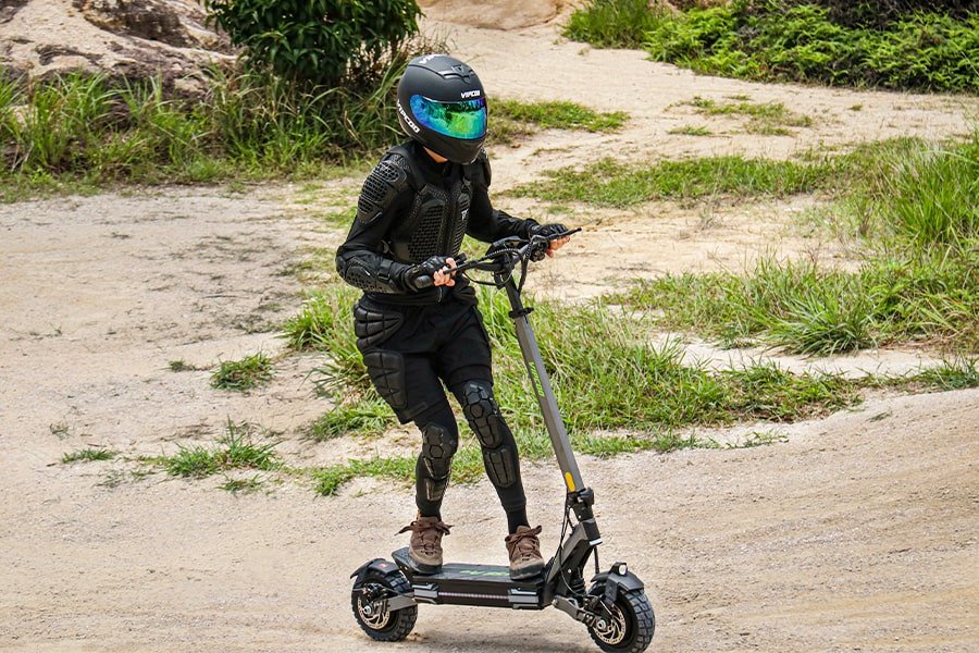 Person riding the VIPCOO VS6 Pro electric scooter on a trail