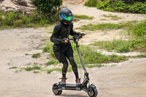 Person riding the VIPCOO VS6 Pro electric scooter on a trail