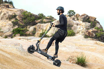Man riding the VIPCOO VS6 Pro electric scooter on a trail