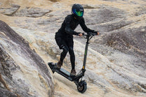 Person riding the VIPCOO VS6 Pro electric scooter on a trail