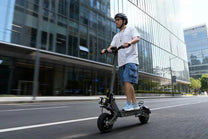 Man riding the VIPCOO VS9 electric scooter in the city