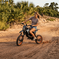 Person riding the Wheely Y88 electric dirt bike on a footpath