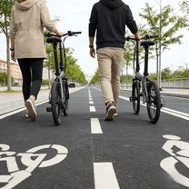 Two riders with the YANGOR H19 folding e-bike in grey on a footpath