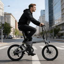 Man riding the YANGOR H19 folding e-bike from the front in grey in the city